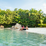Relax around Serenity Bay at Discovery Cove
